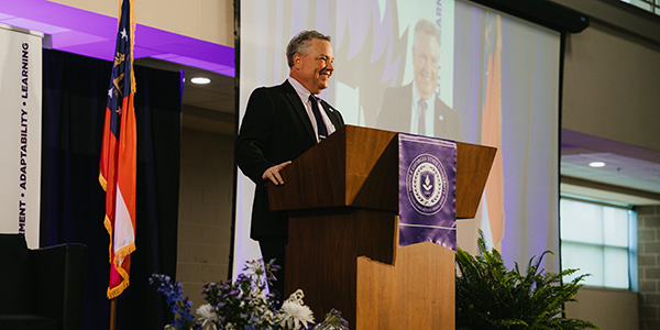 Individual standing at a podium during MGA convcation.